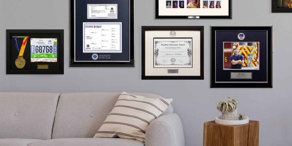 gallery wall of custom frames and shadow boxes hung on wall above couch