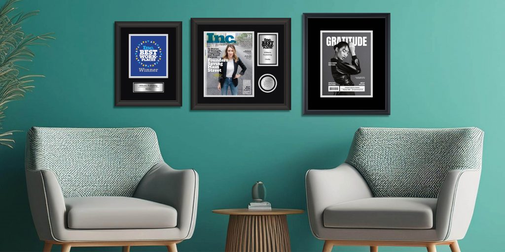 Corporate lobby with three framed achievement awards in custom frames above chairs