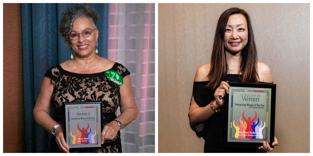 two smiling women holding custom employee award plaques