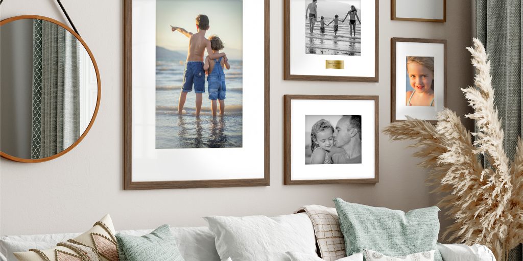 living room wall with custom frames, decorations, and mirror gallery wall display hanging above couch