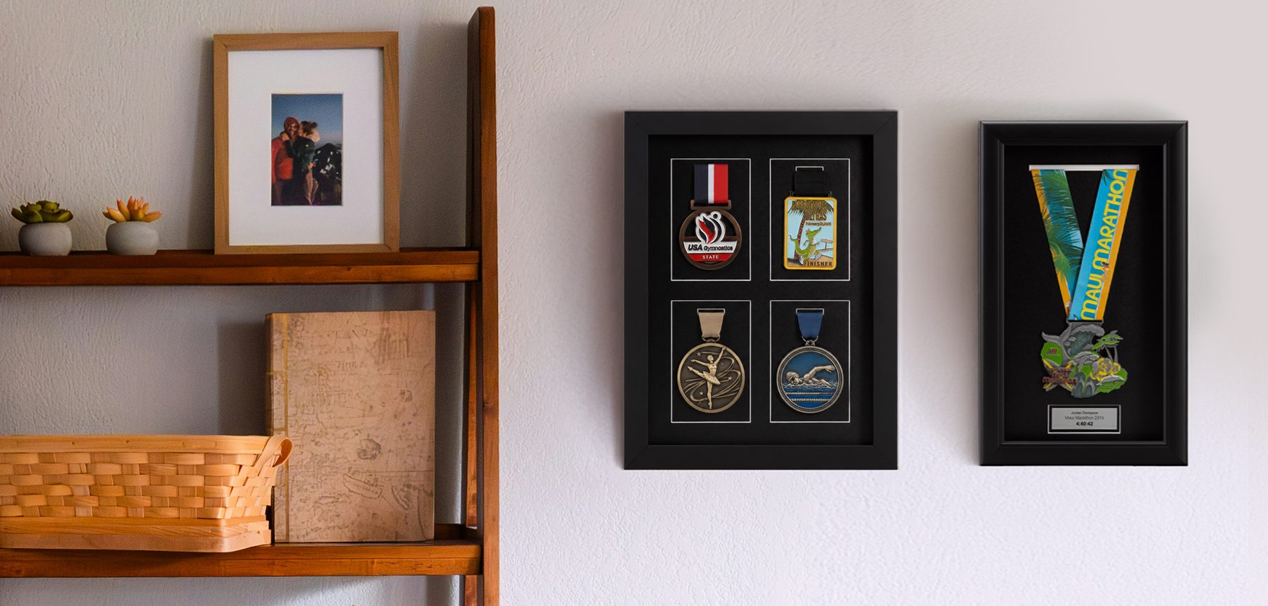 Marathon multi-medal shadow box and marathon medal frame with engraved nameplate on wall next to bookshelf.